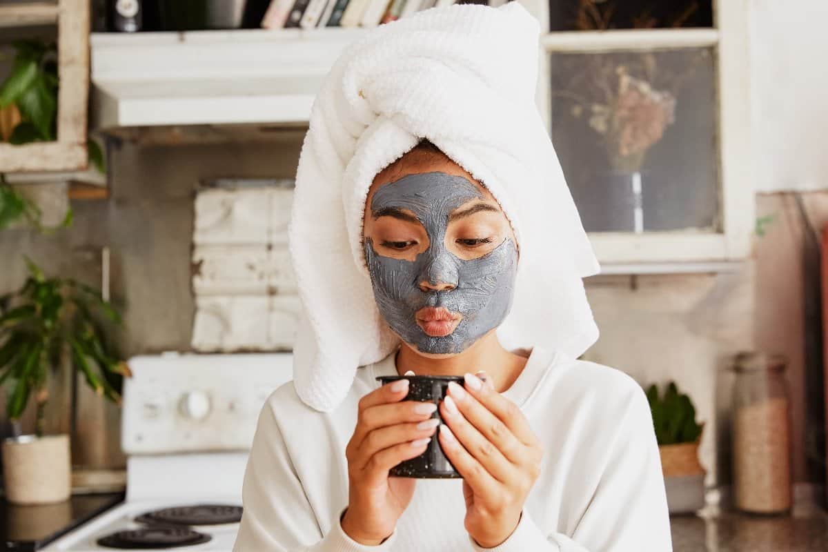 cute asian girl with a facial mask and cup of tea